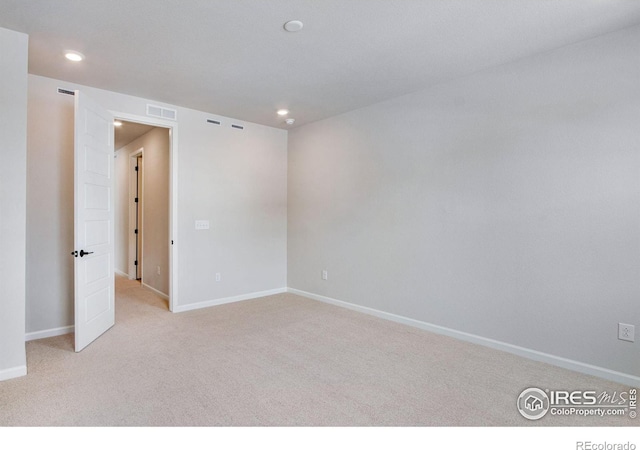 unfurnished room featuring light colored carpet