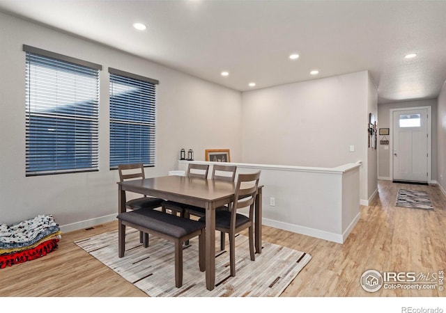 dining space with light hardwood / wood-style floors