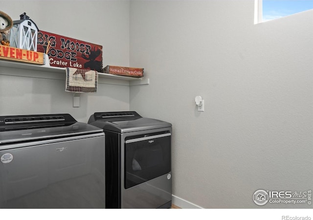 clothes washing area with washing machine and clothes dryer