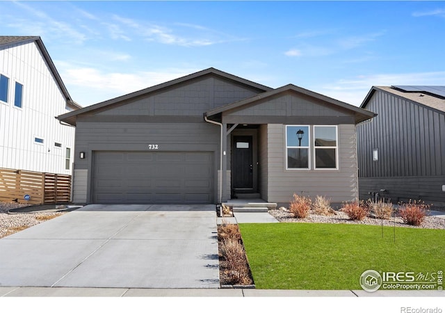 view of front of home featuring a garage and a front lawn