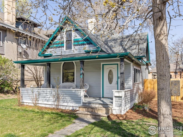 718 Remington St, Fort Collins, CO 80524 - victorian-style house featuring a front lawn and covered porch