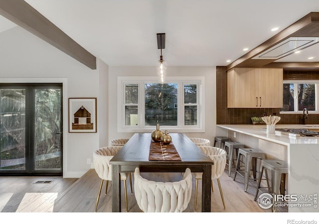 dining space with light hardwood / wood-style flooring