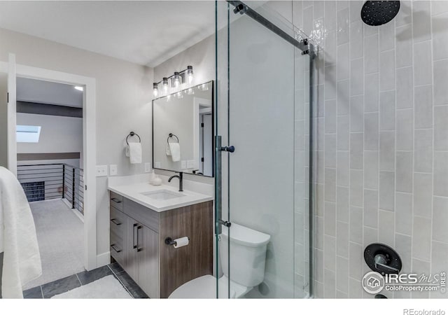 bathroom featuring vanity, toilet, and tile patterned flooring