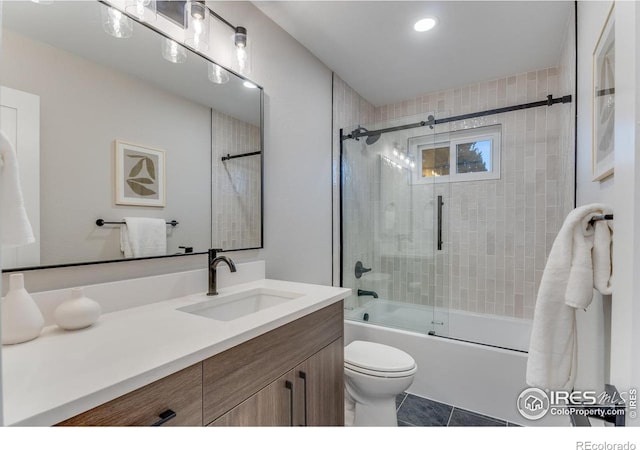 full bathroom with tile patterned floors, vanity, toilet, and combined bath / shower with glass door