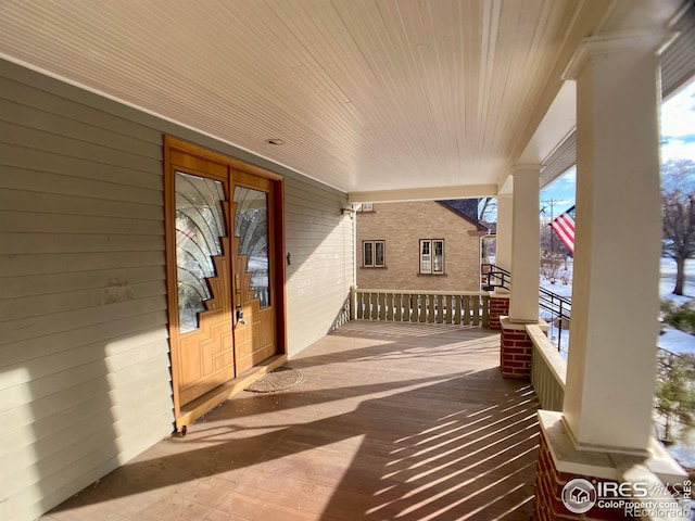 snow covered patio with covered porch