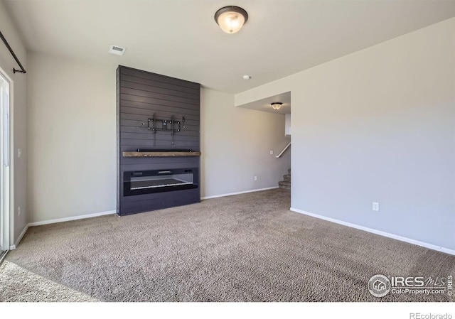 unfurnished living room with carpet flooring