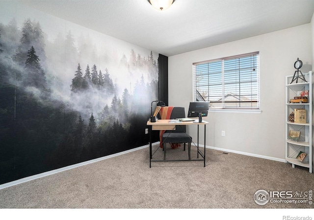 carpeted home office featuring baseboards