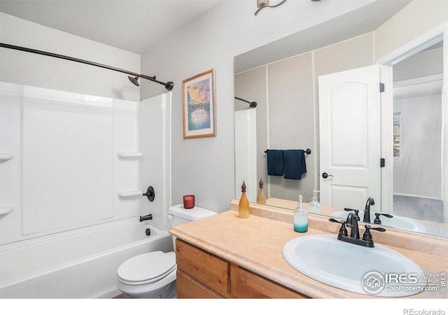bathroom featuring vanity, toilet, and shower / washtub combination