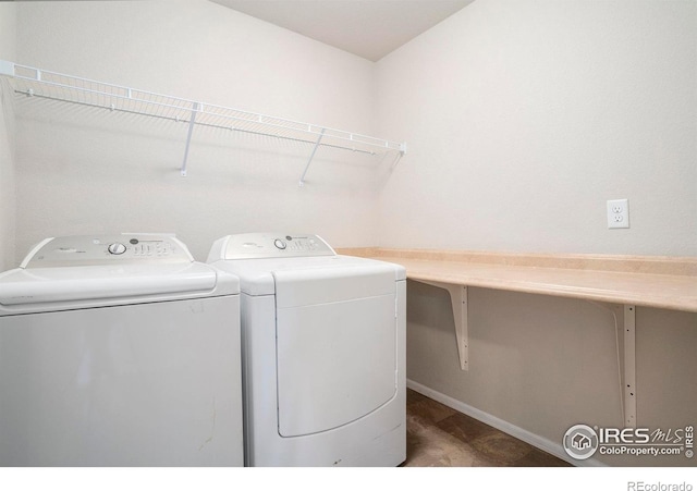 laundry room featuring baseboards, laundry area, and washing machine and dryer