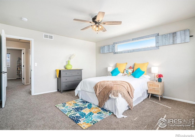 carpeted bedroom with a ceiling fan, baseboards, and visible vents