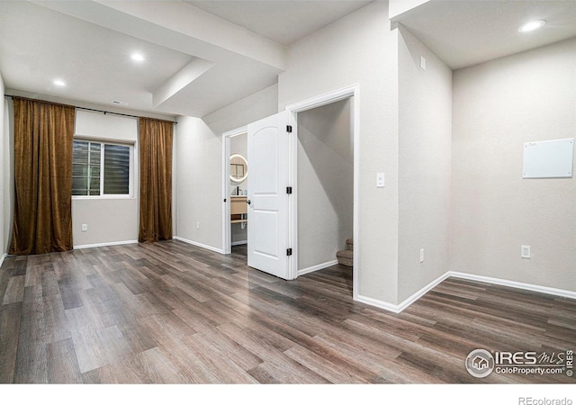 spare room with stairway, baseboards, recessed lighting, and wood finished floors