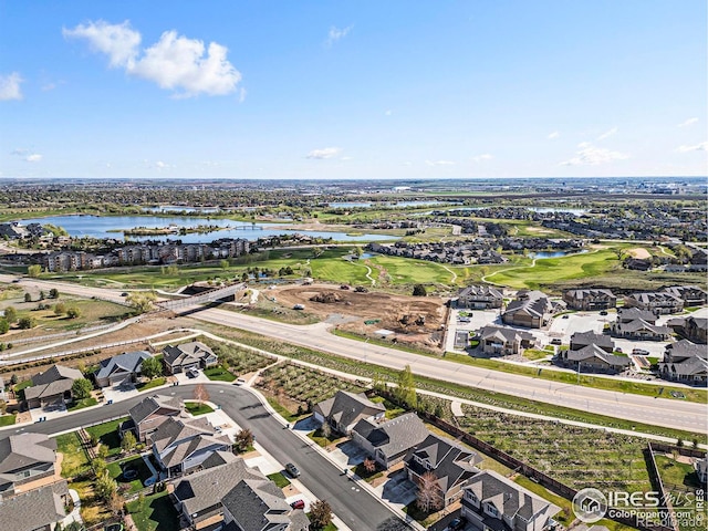 birds eye view of property featuring a water view, view of golf course, and a residential view