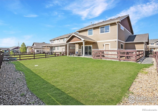 back of house featuring a patio, a fenced backyard, and a yard