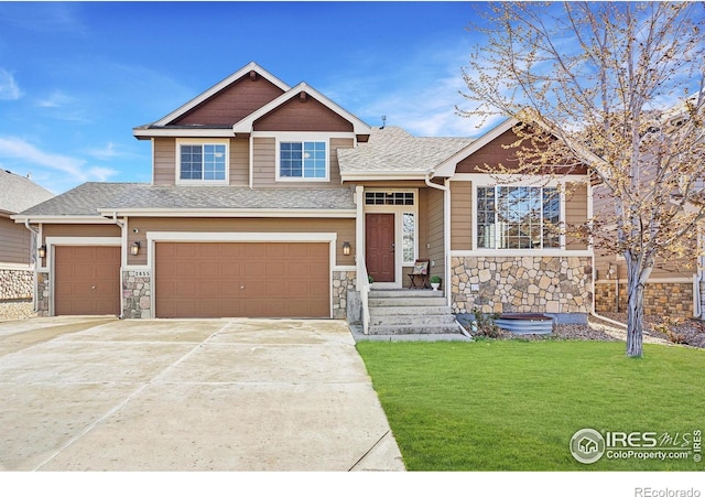 craftsman-style house featuring a garage, stone siding, a front yard, a shingled roof, and driveway