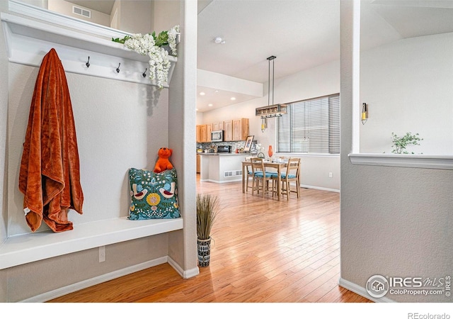 mudroom with recessed lighting, baseboards, visible vents, and light wood finished floors