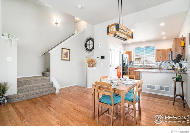 dining space featuring recessed lighting, stairway, visible vents, and light wood finished floors
