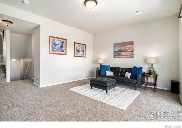 living area featuring visible vents, carpet flooring, and baseboards
