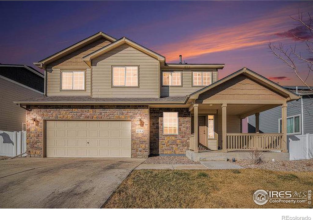 view of front of property with a porch and a garage