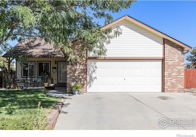 view of front of house featuring a garage and a front lawn