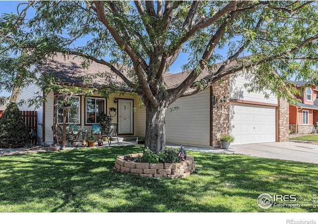 view of front of property with a garage and a front yard