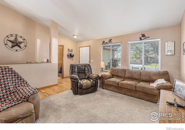 carpeted living room with lofted ceiling