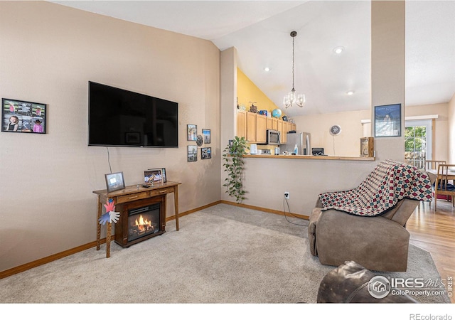 living room with lofted ceiling, light carpet, and an inviting chandelier