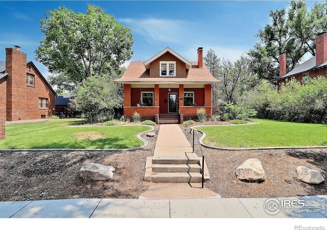 view of front facade with a front yard and a porch