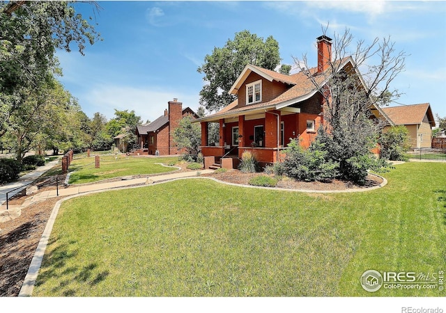 view of front of home with a front yard and covered porch