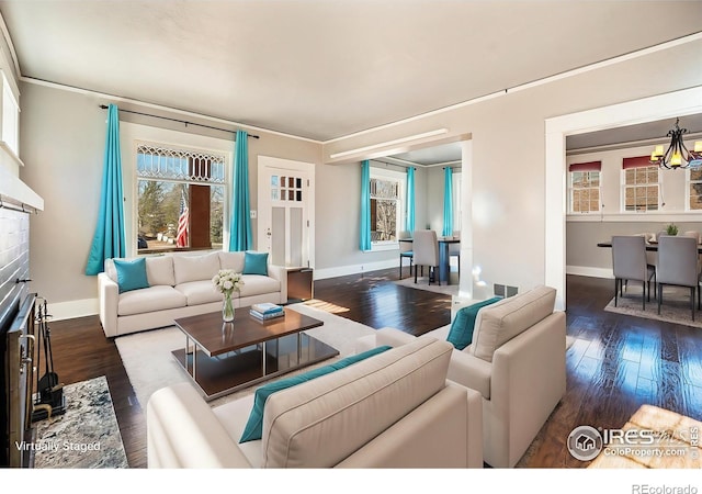 living room featuring dark hardwood / wood-style flooring and a notable chandelier