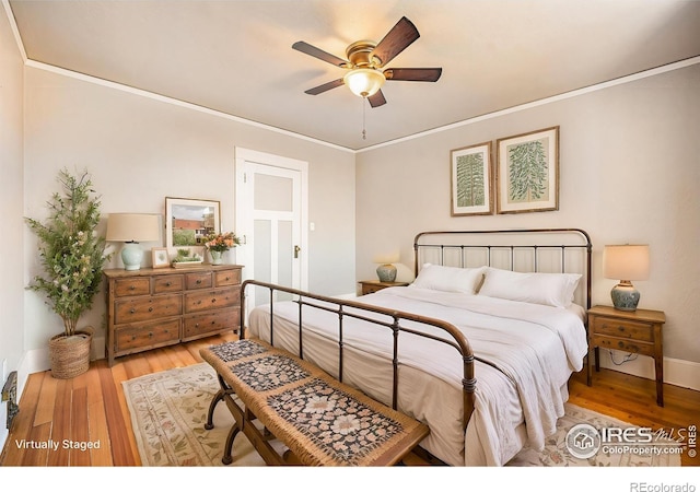 bedroom featuring ceiling fan, ornamental molding, and light hardwood / wood-style floors