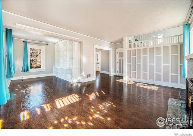 unfurnished living room featuring dark hardwood / wood-style floors