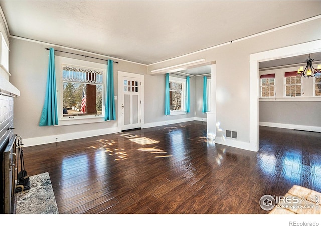 unfurnished living room with crown molding and dark hardwood / wood-style flooring