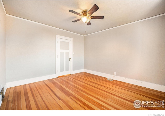 spare room with hardwood / wood-style flooring, ceiling fan, and crown molding