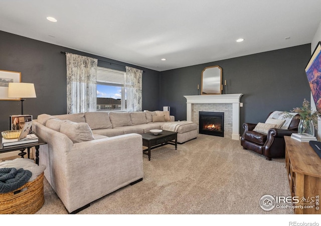 living room featuring a brick fireplace and light colored carpet