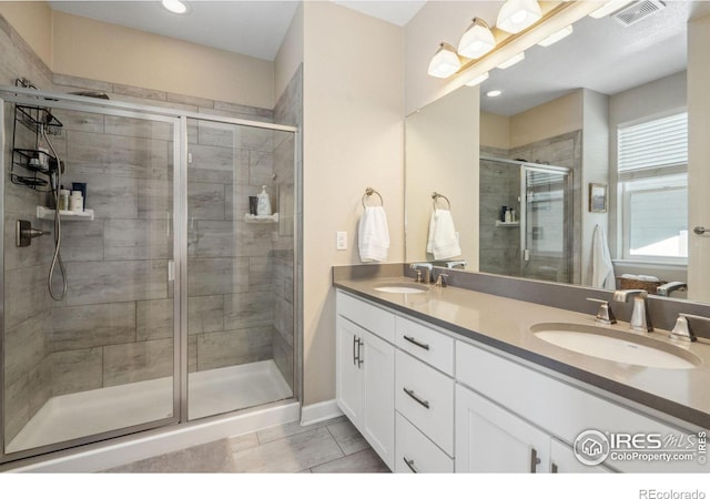 bathroom with vanity and an enclosed shower