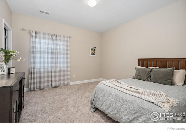 bedroom featuring light colored carpet