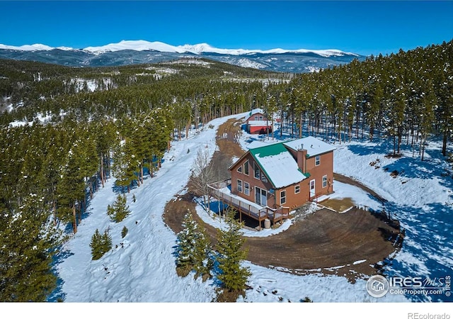 snowy aerial view featuring a mountain view