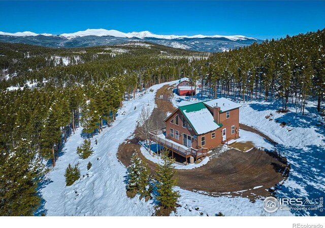 snowy aerial view with a mountain view