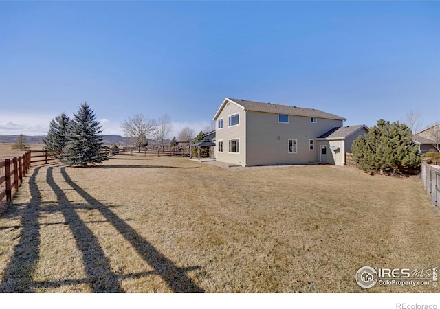 view of yard featuring a fenced backyard and a rural view