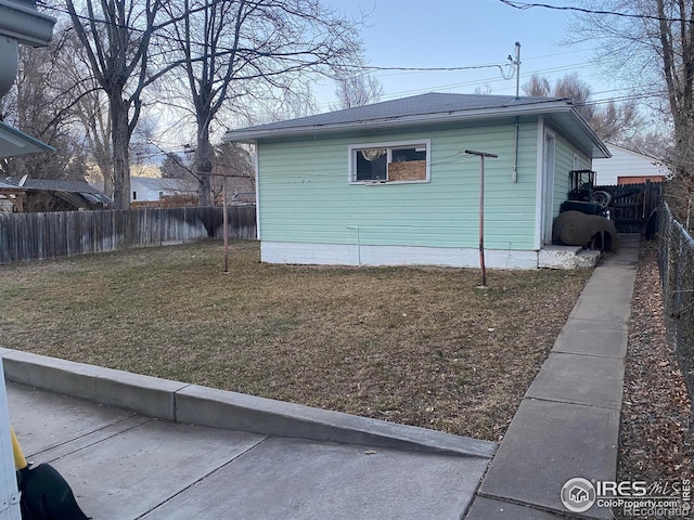 view of side of home with a lawn