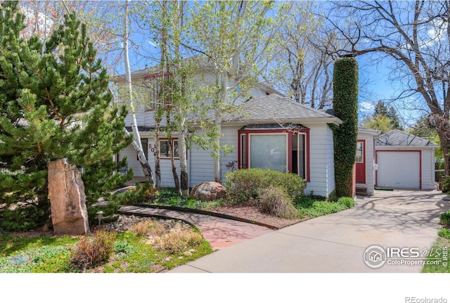 view of front of home with concrete driveway and roof with shingles