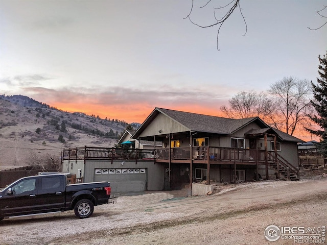 view of front of property with a garage and a deck with mountain view