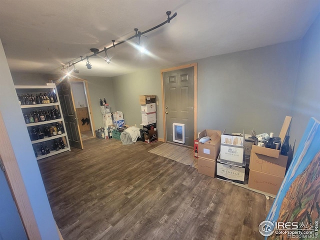 interior space with rail lighting and hardwood / wood-style floors