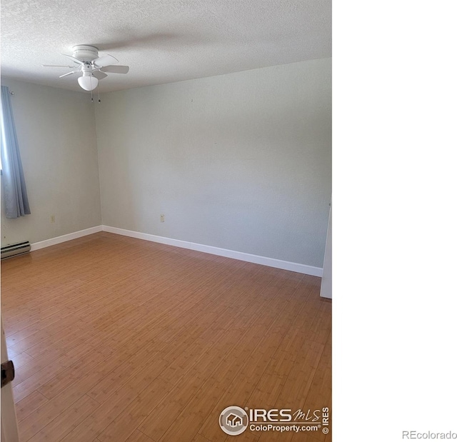 unfurnished room featuring a baseboard radiator, hardwood / wood-style floors, a textured ceiling, and ceiling fan