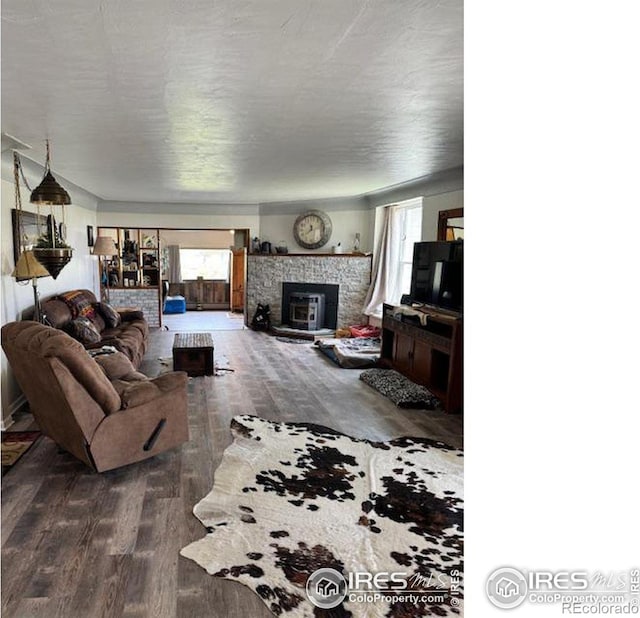 living room with a healthy amount of sunlight, a fireplace, and hardwood / wood-style floors