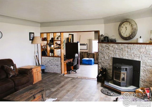 living room featuring a wood stove and dark hardwood / wood-style flooring