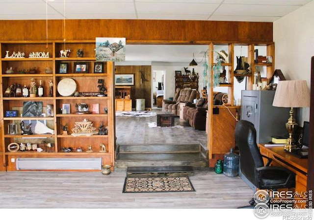 interior space with hardwood / wood-style floors and a drop ceiling