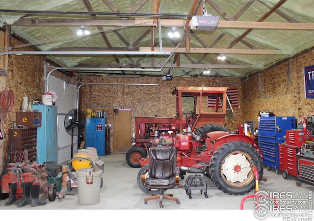 garage featuring a garage door opener and a workshop area