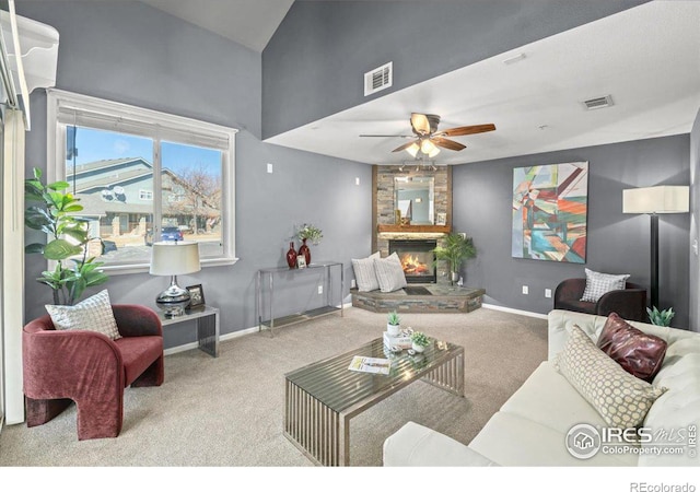 carpeted living room featuring ceiling fan and a fireplace