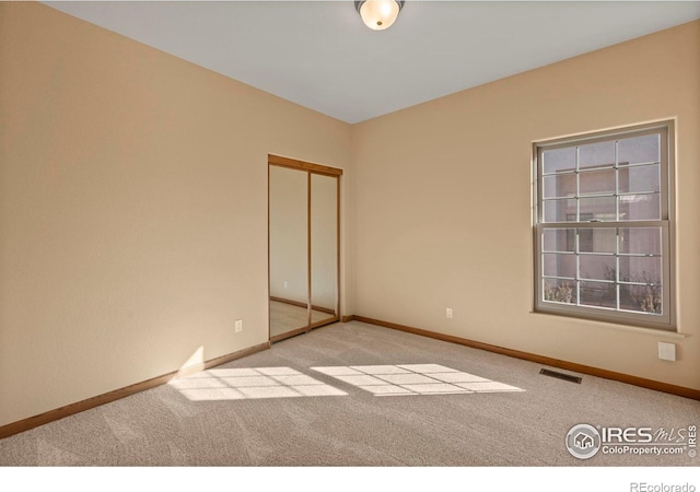 unfurnished room with light colored carpet